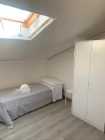 A bed or beds in a room at Hotel Lucerna