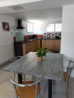 a kitchen with a table with a potted plant on it at L&#39;échappée Comtoise in Baume-les-Dames