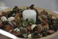 a candle in a pile of shells on a plate at Serenity Apart in Antalya