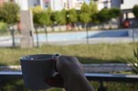 a hand holding a cup of coffee in a park at Serenity Apart in Antalya