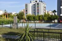 a tennis court in front of a building at Serenity Apart in Antalya