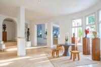 a living room with a table and stools at Surplage Hotel Cavalière in Le Lavandou