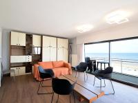 a living room with a view of the ocean at Golf 0401 seafront apartment with balcony in De Haan
