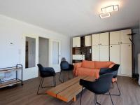 a living room with a bed and chairs in it at Golf 0401 seafront apartment with balcony in De Haan