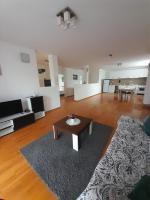 a large living room with a table and a rug at Apartment Ken in Surčin