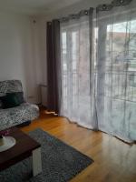 a living room with a couch and a large window at Apartment Ken in Surčin