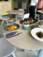 Una mesa con platos de comida encima en LyvInn Hotel Frankfurt, en Frankfurt