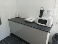 a microwave sitting on top of a counter at O&#39;Couvent - Appartement 62 m2 - 2 chambres - A513 in Salins-les-Bains