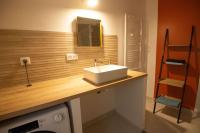 a bathroom with a sink and a washing machine at MAISON DIVISÉE EN 2 APPARTEMENTS POUR 8 PERSONNES in Vermenton