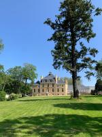 a large house with a tree in the middle of a field at DOMAINE LE MEZO in Ploeren