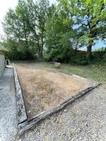 an opening in the ground in a field with trees at Belle villa avec jardin piscine et salle de sport in Montauroux