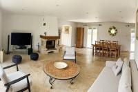 a living room with a couch and a table at Belle villa avec jardin piscine et salle de sport in Montauroux