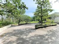 a driveway with trees and a house in the background at Belle villa avec jardin piscine et salle de sport in Montauroux