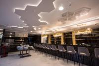 a restaurant with a bar with chairs and a ceiling at Hotel Crystal in Orebić