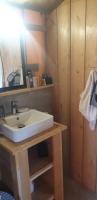 a bathroom with a white sink and a mirror at Larah Land 4 Star Glamping Yala Lodge plus kids lodge in Šimuni