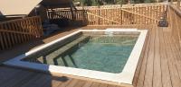 a swimming pool on the deck of a house at Larah Land 4 Star Glamping Yala Lodge plus kids lodge in Šimuni