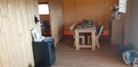 a room with a table and a table and chairs at Larah Land 4 Star Glamping Yala Lodge plus kids lodge in Šimuni