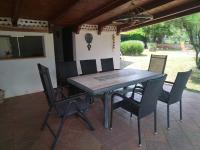 a wooden table and chairs on a patio at Spacious Holiday Home in Verteneglio in Brtonigla