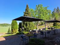a group of tables and chairs under umbrellas at Hotelli Siuntio in Siuntio