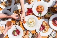 ein Tisch voller Teller mit Essen in der Unterkunft Grandhotel Sluchátko - EX Zámecký hotel in Vranov nad Dyjí