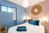 a bedroom with blue walls and a large bed with blue pillows at Le Nani Raou par Dodo à Cassis in Cassis