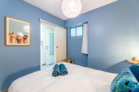 a bedroom with blue walls and a bed with blue shoes on it at Le Nani Raou par Dodo à Cassis in Cassis