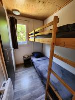 a bedroom with two bunk beds and a ladder at Le clos de lignac in Cieux
