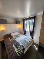 a bedroom with a bed with a zebra blanket at Le clos de lignac in Cieux