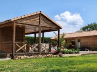 a wooden gazebo in the yard of a house at Le clos de lignac in Cieux
