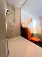 a shower in a bathroom with a glass door at Altötting City Apartments in Altötting