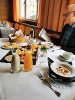 a man sitting at a table with a plate of food at Altötting City Apartments in Altötting