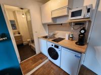 a small kitchen with a stove and a microwave at L&#39;Escale Lafayette - Appartement Rive Gauche in Rouen