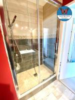 a shower with a glass door in a bathroom at Le Nid Douillet, proche du centre-ville in Limoges