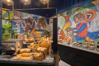 a mural on the wall of a bakery with pastries at Eastin Grand Hotel Phayathai in Bangkok