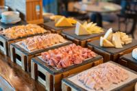 a display of different types of meats and cheese at Eastin Grand Hotel Phayathai in Bangkok