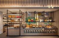 a bakery display case with a bunch of food at Eastin Grand Hotel Phayathai in Bangkok