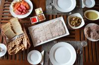 a table topped with plates and bowls of food at Malala Retreat in Hambantota