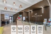un vestíbulo del hotel con carteles en la pared en Hotel Adler, en Friedrichshafen