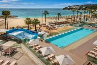 an aerial view of a resort with a swimming pool and the beach at INNSiDE by Meliá Wave Calviá in Magaluf