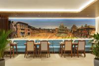 a dining room with a painting of a city at Hotel Thrive, A Tropical Courtyard in Kathmandu