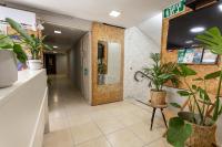ein Büroflur mit Pflanzen und einem Fernseher an der Wand in der Unterkunft Little Prince Hostel-5 Min Walk To The Beach in Eilat