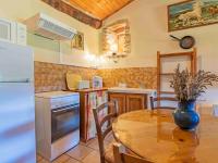 a kitchen with a wooden table and a dining room at Holiday Home Le Cèdre - RSB100 by Interhome in Roche-Saint-Secret