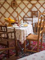 a table in a yurt with a bowl of fruit on it at Yourtissimo in Laprugne