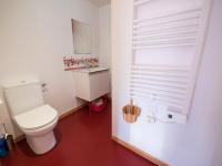 a bathroom with a white toilet and a window at Yourtissimo in Laprugne