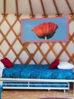 a room with a bed in a yurt at Yourtissimo in Laprugne