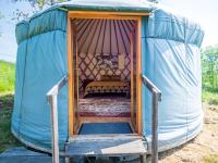 a blue tent with a bed in it at Yourtissimo in Laprugne