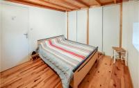 a bed in a room with a wooden floor at Amazing Home In Essertines-en-chtelne With 3 Bedrooms in Essertines-en-Châtelneuf