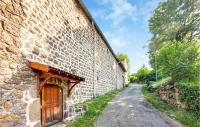 an old stone building with a wooden door on the side of a road at Amazing Home In Essertines-en-chtelne With 3 Bedrooms in Essertines-en-Châtelneuf