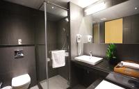 a bathroom with a toilet and a sink and a shower at Chiayi Guanzhi Hotel in Chiayi City