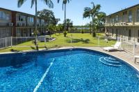 a large blue swimming pool in front of a building at Mid City Motor Inn in Mackay